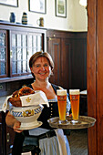 Waitress serving traditional white sausages and wheat beer in restaurant Grossmarkthalle, Sendling, Munich, Upper Bavaria, Bavaria, Germany