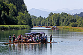 People on a traditional wood raft, river Isar, Munich, Upper Bavaria, Bavaria, Germany