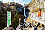 Tourists taking photo of Nikko Kegon Falls from viewpoint in Nikko, Tochigi Prefecture, Japan