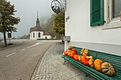 Foggy morning near Balsthal, canton Solothurn, Switzerland. Chapel of Sankt Wolfgang in the background.
