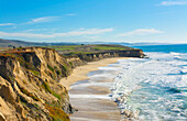 Half Moon Bay California shore ocean cliffs off of the Ritz Golf Course with waves sand at Half Moon Bay Golf Links.