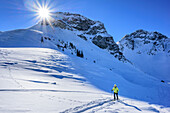 Woman backcountry skiing ascending towards Saalkogel, Saalkogel, Kitzbuehel Alps, Tyrol, Austria