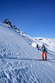 Frau auf Skitour steigt zu Geier auf, Lizumer Reckner im Hintergrund, Geier, Tuxer Alpen, Tirol, Österreich