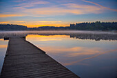 'Reflection of a beautiful serene sunrise on peaceful Scott lake; Washington, United States of America'