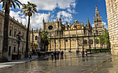 'View of Seville Cathedral and Archivio de Indias from Real Alcazar entrance; Seville, Andalusia, Spain'