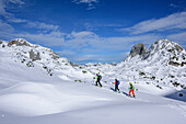 Three persons backcountry skiing ascending towards Fritzerkogel, Fritzerkogel, Tennengebirge range, Salzburg, Austria