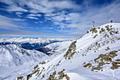 Woman backcountry skiing walking towards the cross on summit of Grosser Schafkopf, Grosser Schafkopf, valley Langtauferer Tal, Oetztal Alps, Vinschgau, South Tyrol, Italy