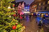 Colourful lights on Christmas trees and ornaments at dusk, Colmar, Haut-Rhin department, Alsace, France, Europe