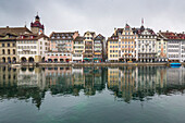 The typical buildings of the old medieval town are reflected in River Reuss, Lucerne, Switzerland, Europe