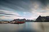 The summer sunset at night on fishing village and cold sea, Hamnoy, Moskenesoya, Nordland county, Lofoten Islands, Norway, Scandinavia, Europe