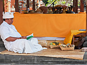 Man relaxing in a temple, Denpasar, Bali, Indonesia, Southeast Asia, Asia