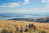Group of young people enjoying a picnic on the Port Hills, Christchurch, Canterbury, South Island, New Zealand, Pacific