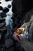 A woman rock climbing on the Jogasaki Coast, Izu Peninsula, Honshu, Japan, Asia