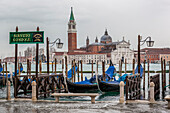 Italy, Veneto, Venice, Gondolas and view of San Giorgio Maggiore Isle from Palazzo Ducale Pier