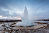 Strokkur Geyser eruption at dawn, Haukadalur Geothermal Area, Haukadalur, Arnessysla, Sudurland, Iceland, Europe