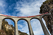 Bernina Express red train along Landwasser Viaduct, Filisur, Graubunden, Switzerland, Europe