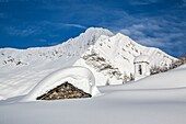 The huts and the bell tower of Alpe Scima sorrounded by metres of snow, Alpe Scima, Valchiavenna, Valtellina Lombardy, Italy Europe