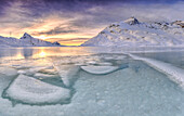 Sunrise lights the frozens surface ok White Lake at Bernina Pass, Canton of Graubuenden, Engadine, Switzerland, Europe