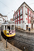 Yellow tram number 28 performs the longest route leading from centre of town up to the top of Alfama Lisbon Portugal Europe