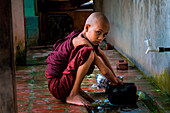 Mahagandayon Monastery, Amarapura, Myanmar, South East Asia, young buddhist novices, who conducts his daily activities inside the monastery Mahagandayon