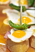 Fried eggs with Green pepper. Pintxos or Tapas. Food very Typical in the Basque country. San Sebastián (Donostia), Gipuzkoa, Basque Country, Spain