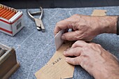 At a tailor in Barcelona, Spain. Production process of suit tailoring. drawing the outline of parts of a tailored jacket.