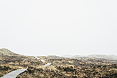 Scenic view of field against sky in foggy weather