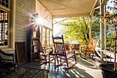 Reflection of sun on porch with rocking chairs