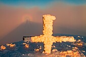 Europe, Italy, Lombardy, Valtellina, Spectrum of broken from summit alpin cross at sunset