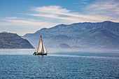 Sail boat on the waters of Lake Como, Lombardy, Italy