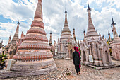 Kakku, Taunggyi, Shan State, Myanmar Birmania , A woman walking between the 2478 stupas
