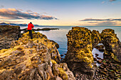 Snaefellsness peninsula, Iceland, Man standing over a rock formation along the coast