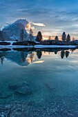 Europe, Italy, Veneto, Falzarego, Belluno, Morning view of the Tofana di Rozes reflected in the calm water of the Limedes lake, Dolomites