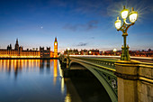 Night view of Palace of Westminster and Big Ben reflecting on Thames river