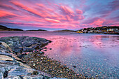 Pink sky at sunrise reflected in the cold waters Flatanger Tr?ndelag Norway Europe