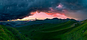 Crocedomini Pass, Adamello Park, Lombardy, Italy The colors of the sunset in the clouds of two storms, Panoramic photo of the valley below the pass Crocedomini