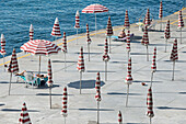 High angle view of striped parasols and women on  beach