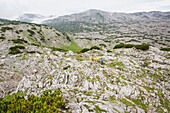 Hikers in karst landscape, Totes Gebirge, Bad Aussee, Styria, Austria, Europe