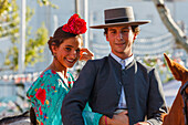 horseriding couple at the Feria de Abril, Seville Fair, spring festival, Sevilla, Seville, Andalucia, Spain, Europe