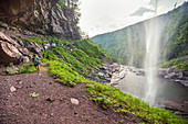 Hiker Walking Under The Kaaterskill Waterfalls, New York, Usa