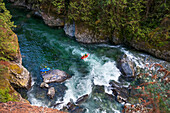Three Men Packrafting Along The Chehalis River, British Columbia, Canada