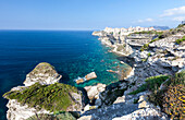 Turquoise sea frames the medieval old town and fortress perched on top of cliffs, Bonifacio, Corsica, France, Mediterranean, Europe