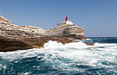 Waves of the turquoise sea crashing on the granite white cliffs and lighthouse, Lavezzi Islands, Bonifacio, Corsica, France, Mediterranean, Europe