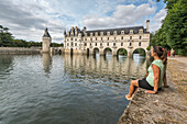 Woman staring at Chenonceau castle, UNESCO World Heritage Site, Chenonceaux, Indre-et-Loire, Centre, France, Europe