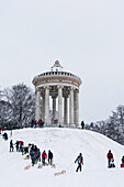 Sledging during Snow Fall at Monopteros, English Garden, Munich, Germany