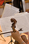 A musician holds her violin during a rehearsal in Portland, Maine.