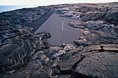USA, Hawaii, Volcanoes National Park,  Lava flow from Kilauea volcano covers old highway on Big Island