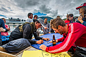 Team Members Enjoying On Dock During The Race To Alaska