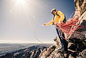 Man hiking and climbing the Grand Teton in Grand Teton National Park, Wyoming.