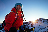 A woman backcountry skiing in the Wasatch mountains.